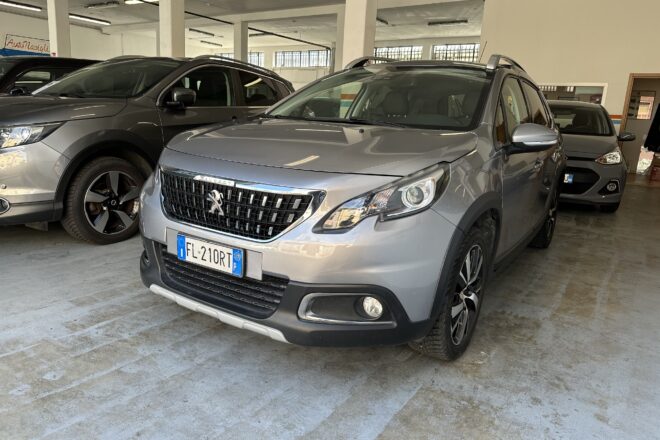 Grey Peugeot SUV in a car showroom with other vehicles and concrete pillars nearby