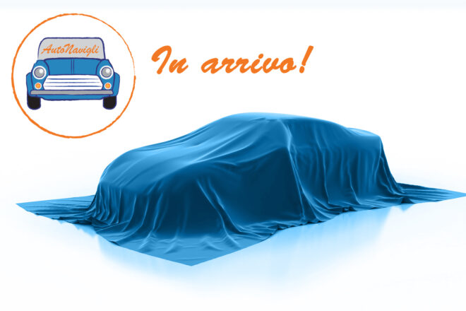 Blue car under a satin cover on a white studio background, with orange 'In arrivo!' text and a circular logo featuring a blue car labeled 'AutoNawili'.