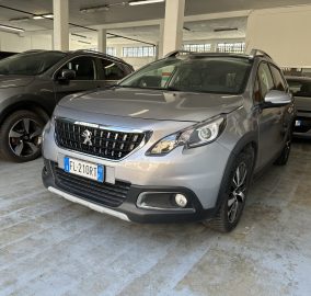 Grey Peugeot SUV in a car showroom with other vehicles and concrete pillars nearby