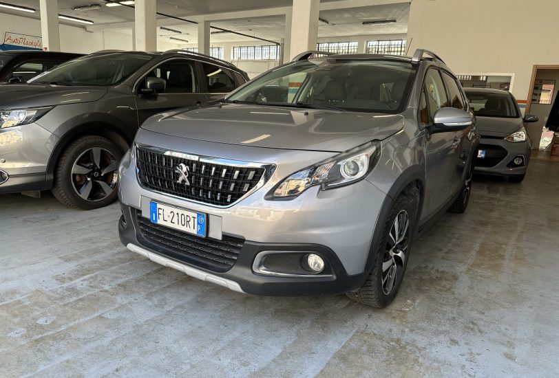 Grey Peugeot SUV in a car showroom with other vehicles and concrete pillars nearby