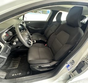 Interior of a car showing the driver and front passenger seats, steering wheel, and dashboard.