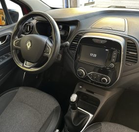 Interior of a car focusing on the steering wheel, center console, and gear shift.